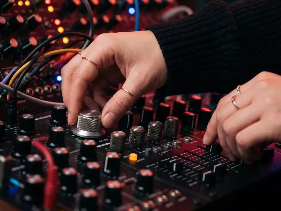 Hands adjusting synth controls while building a phonk beat in the PhonkMaker AI phonk maker.